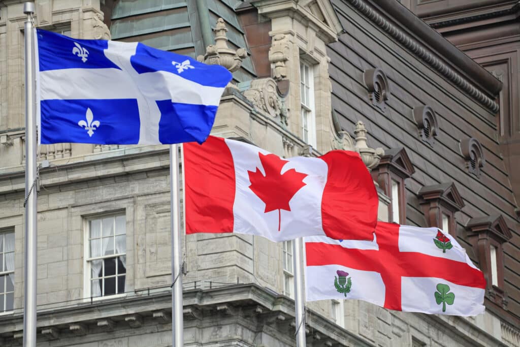 Quebec, Canadian and Montreal flags waving
